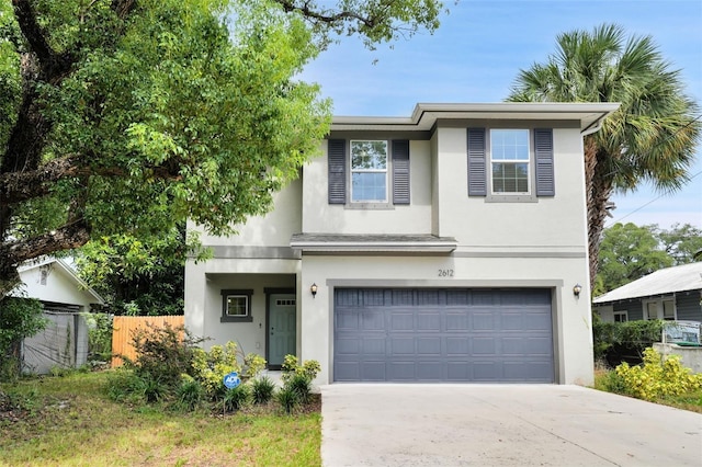 2612 E 26th Ave, Tampa, FL 33605 - view of front of property featuring concrete driveway, fence, a garage, and stucco siding