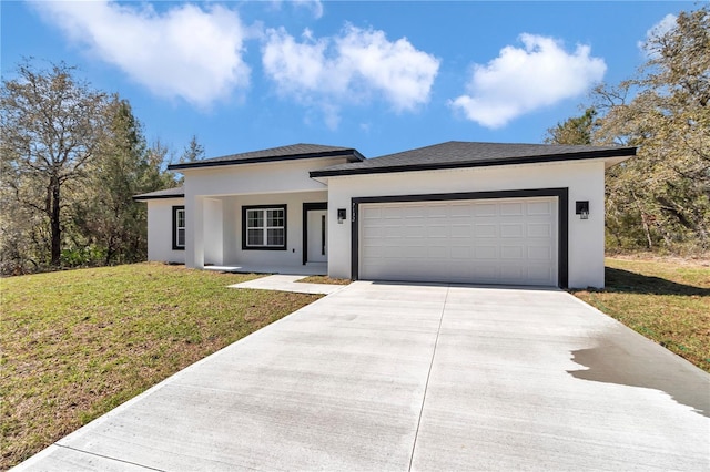 view of front facade with a front lawn, an attached garage, concrete driveway, and stucco siding