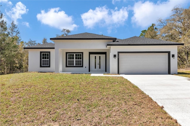 view of front of house with a front lawn, stucco siding, french doors, a garage, and driveway