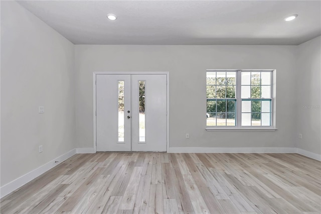 entryway with recessed lighting, light wood-style floors, and baseboards