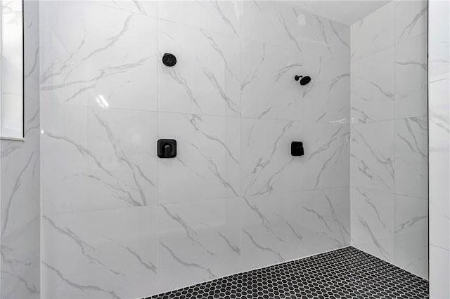 bathroom with a tile shower