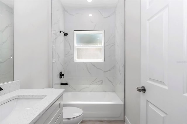 bathroom with vanity, shower / bathtub combination, and toilet