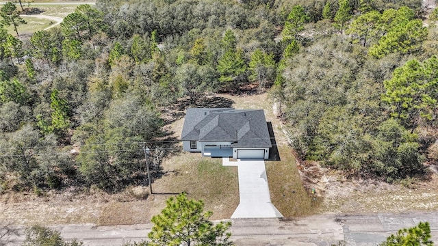 drone / aerial view featuring a view of trees