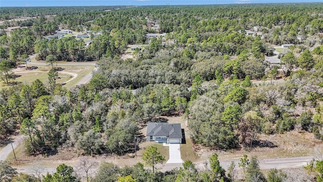 drone / aerial view featuring a forest view