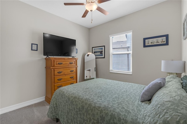 carpeted bedroom featuring a ceiling fan and baseboards