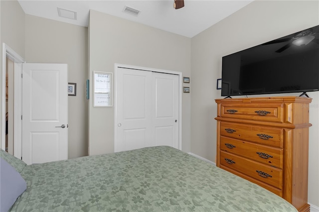 bedroom with a closet, visible vents, and a ceiling fan