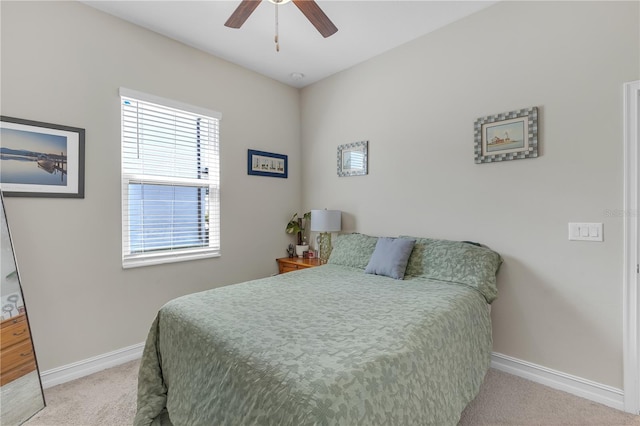 bedroom with ceiling fan, baseboards, and carpet