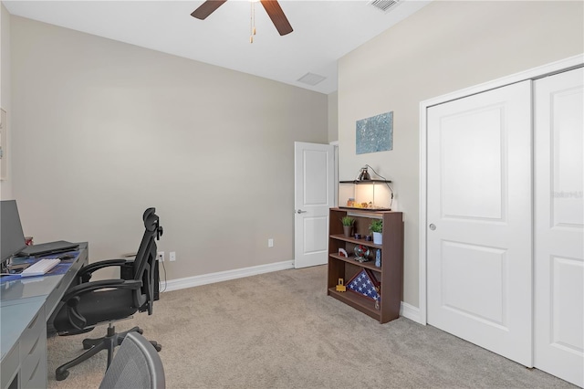 home office featuring ceiling fan, visible vents, baseboards, and light carpet