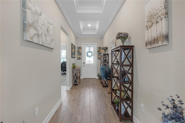 interior space with baseboards, wood finished floors, and ornamental molding