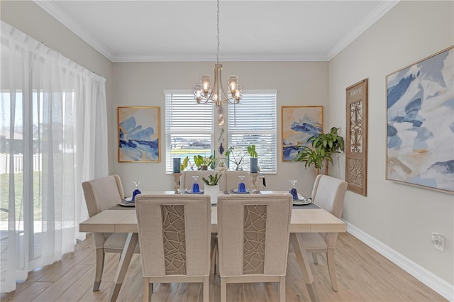 dining space featuring a chandelier, light wood-type flooring, baseboards, and ornamental molding