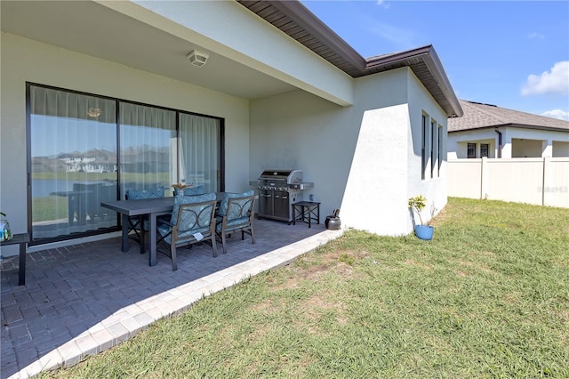 exterior space featuring a grill and fence