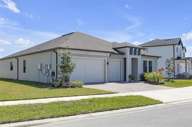 view of front facade featuring a front lawn, an attached garage, concrete driveway, and stucco siding