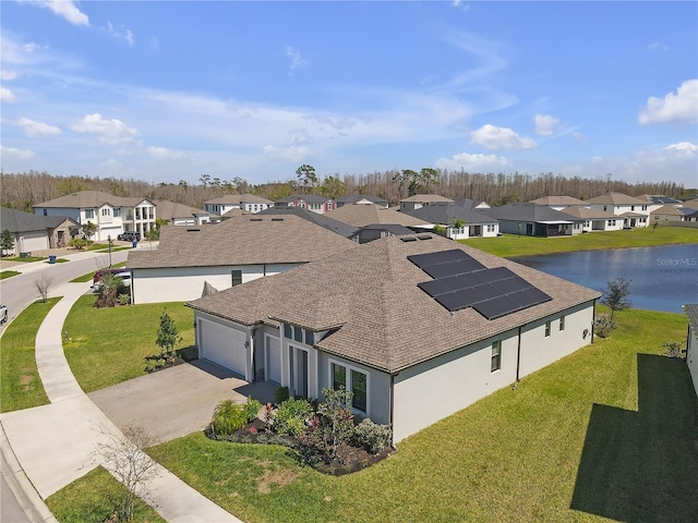 bird's eye view with a residential view and a water view