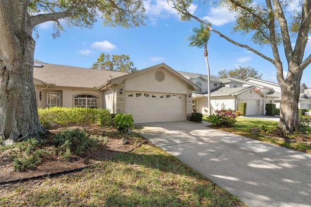 ranch-style house with stucco siding, an attached garage, concrete driveway, and a shingled roof