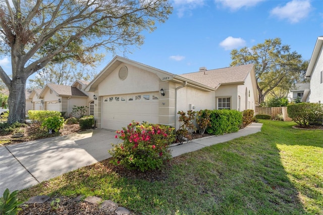 single story home featuring a front yard, fence, an attached garage, stucco siding, and concrete driveway