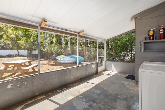 unfurnished sunroom featuring independent washer and dryer