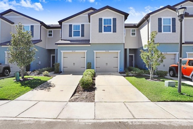 multi unit property with concrete driveway, a garage, and stucco siding