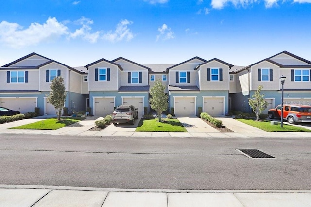 townhome / multi-family property with a residential view, an attached garage, and concrete driveway