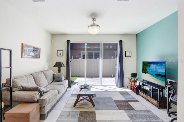 living area featuring light tile patterned floors and visible vents