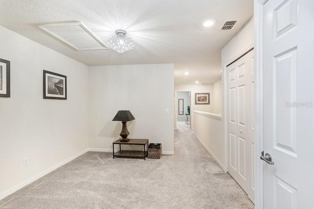 hall with light carpet, visible vents, recessed lighting, and baseboards