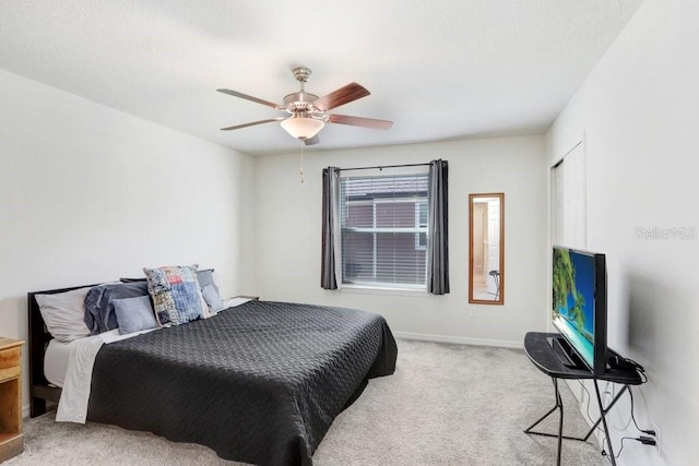 bedroom featuring a ceiling fan, carpet, and baseboards