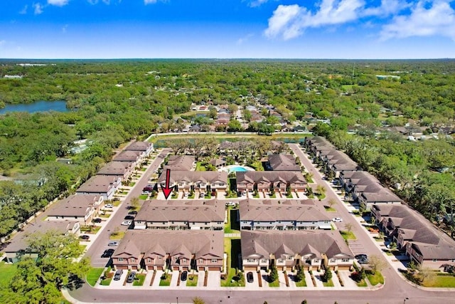 aerial view with a residential view, a wooded view, and a water view