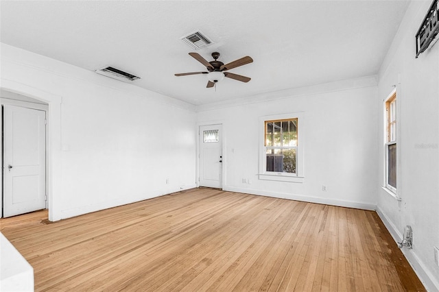 empty room featuring visible vents, baseboards, ceiling fan, and light wood finished floors