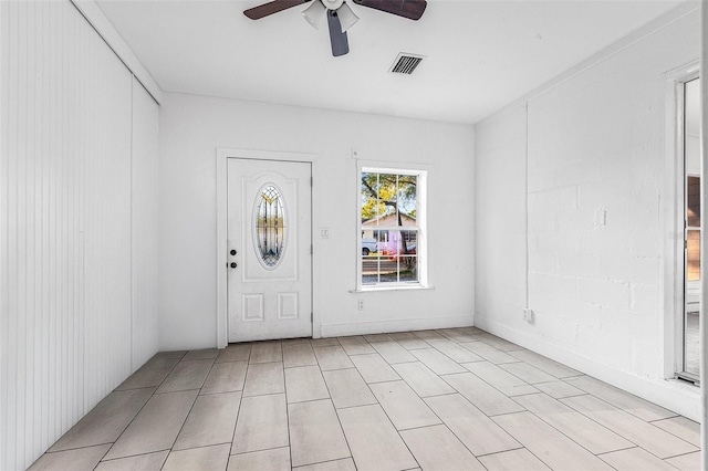 entrance foyer featuring light tile patterned floors, visible vents, and a ceiling fan