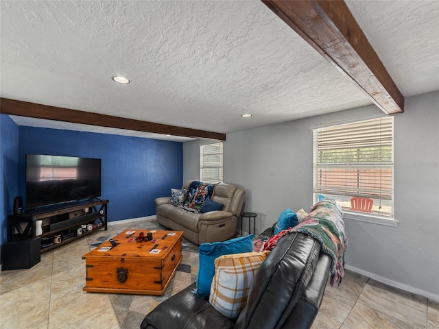 living room with baseboards, beam ceiling, and a textured ceiling