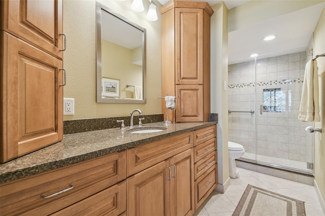 bathroom featuring tile patterned flooring, toilet, recessed lighting, a stall shower, and vanity