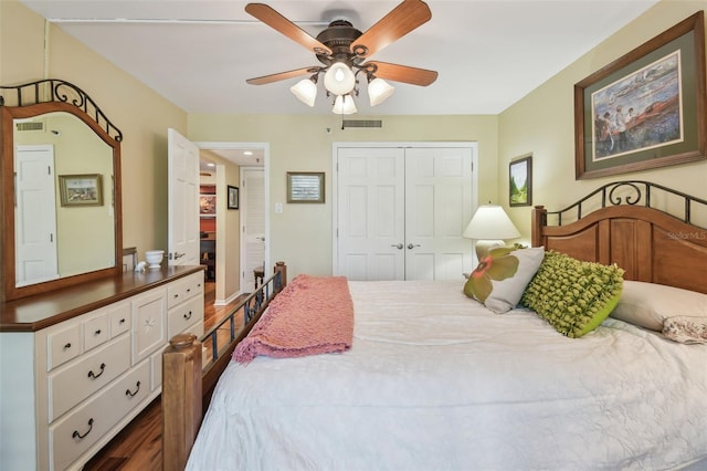 bedroom with a closet, visible vents, dark wood finished floors, and a ceiling fan