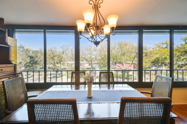 sunroom featuring a notable chandelier