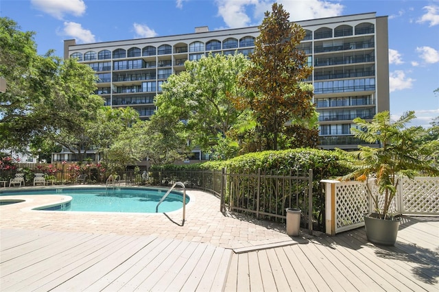 pool featuring a wooden deck and fence