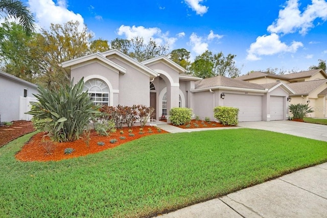 view of front of house with stucco siding, concrete driveway, a front yard, and a garage