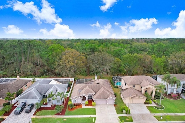 drone / aerial view featuring a residential view and a forest view