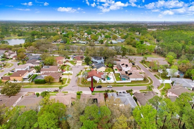 drone / aerial view featuring a residential view and a water view