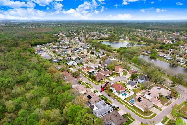 drone / aerial view with a residential view and a water view