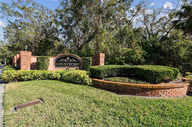 community sign featuring a lawn