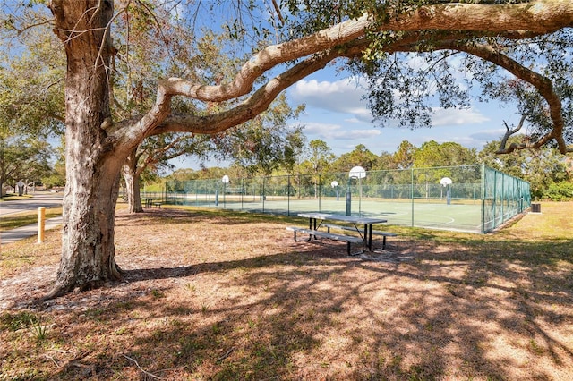 view of property's community with community basketball court and fence