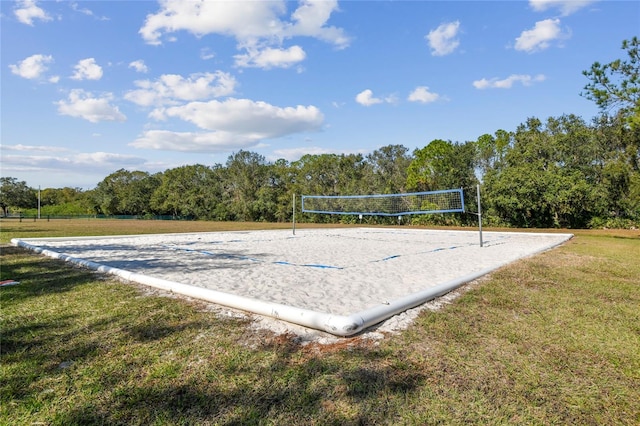 view of home's community with volleyball court and a lawn