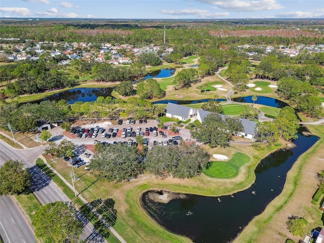 aerial view with golf course view and a water view