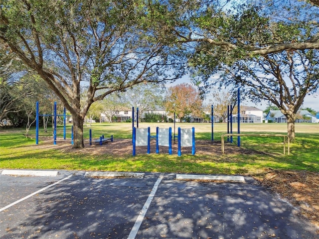 surrounding community with a yard and uncovered parking