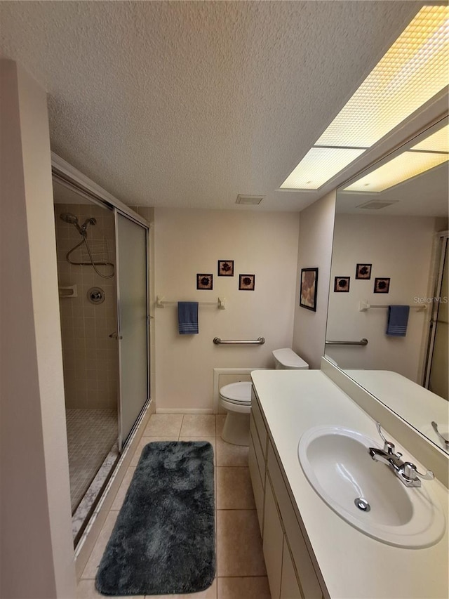 full bath with tile patterned flooring, toilet, a stall shower, and a textured ceiling