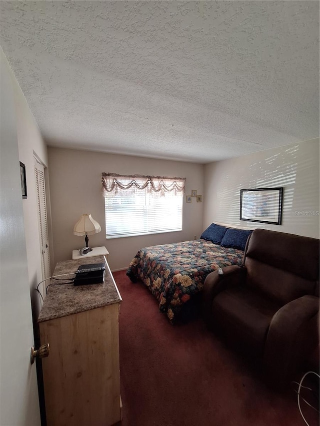 carpeted bedroom featuring a closet and a textured ceiling