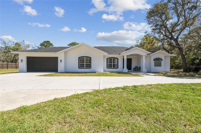 single story home with a front yard, fence, driveway, an attached garage, and stucco siding