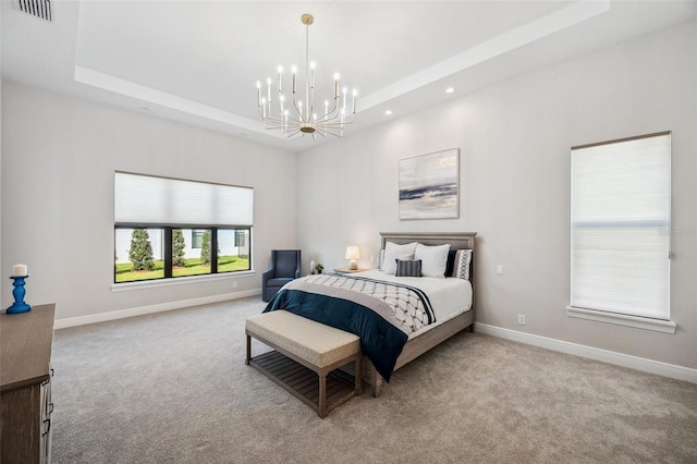 bedroom with a tray ceiling, baseboards, a notable chandelier, and carpet flooring