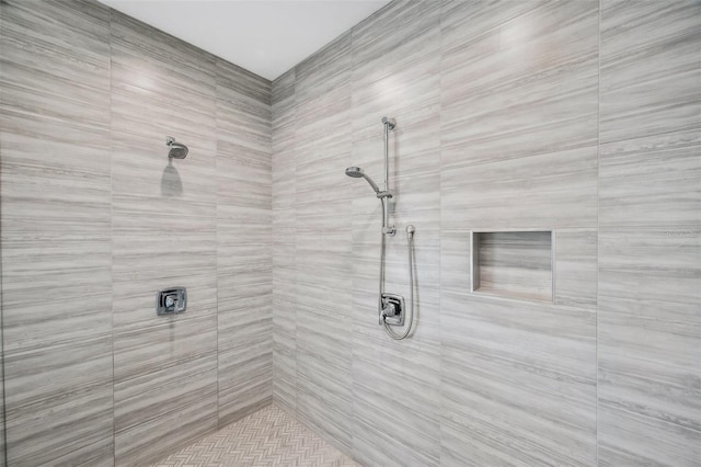 bathroom with a tile shower