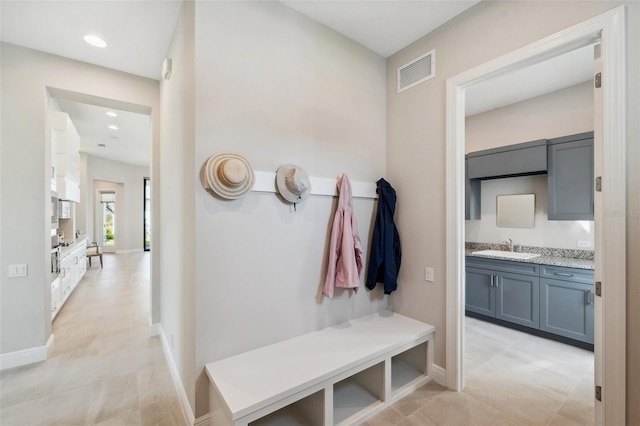 mudroom with visible vents, recessed lighting, baseboards, and a sink