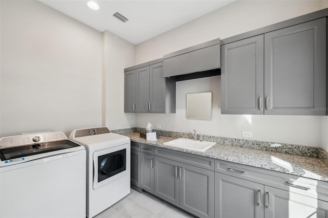 laundry area with visible vents, recessed lighting, cabinet space, a sink, and independent washer and dryer