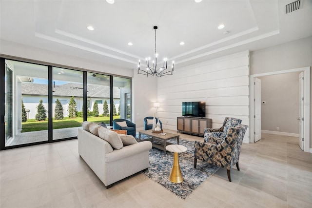 living room featuring visible vents, a notable chandelier, a tray ceiling, light tile patterned floors, and baseboards